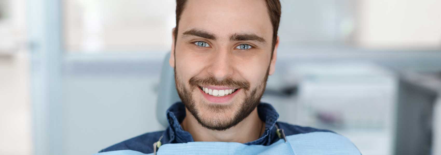 Handsome man smile after dental bridge treatments
